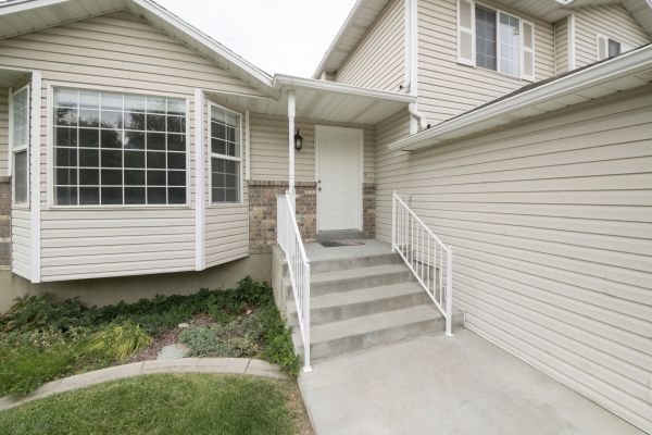 White Vinyl Siding Replacement in Brick